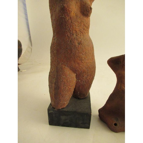 231 - A clay model of a female torso, attributed to Karin Jonzen, with her hands behind her head raised on... 