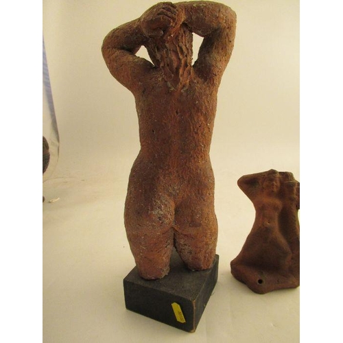 231 - A clay model of a female torso, attributed to Karin Jonzen, with her hands behind her head raised on... 