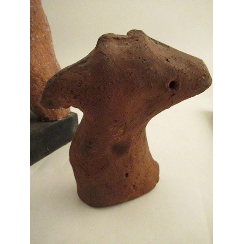 231 - A clay model of a female torso, attributed to Karin Jonzen, with her hands behind her head raised on... 