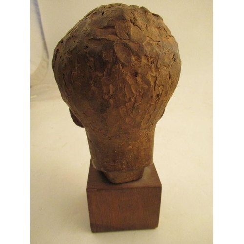 232 - A clay head of a young boy signed to the reverse Karin Jonzen, raised on a wooden pedestal  height a... 