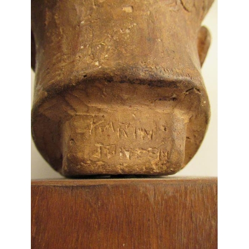 232 - A clay head of a young boy signed to the reverse Karin Jonzen, raised on a wooden pedestal  height a... 