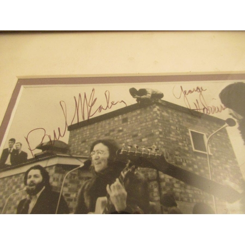 253 - A framed photograph of The Beatles ,together with a signed photograph including a sketch by John Len... 