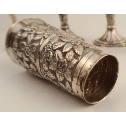 295 - A collection of Indian white metal, to include a pair of vases, height 6.25ins, a single vase and tw... 