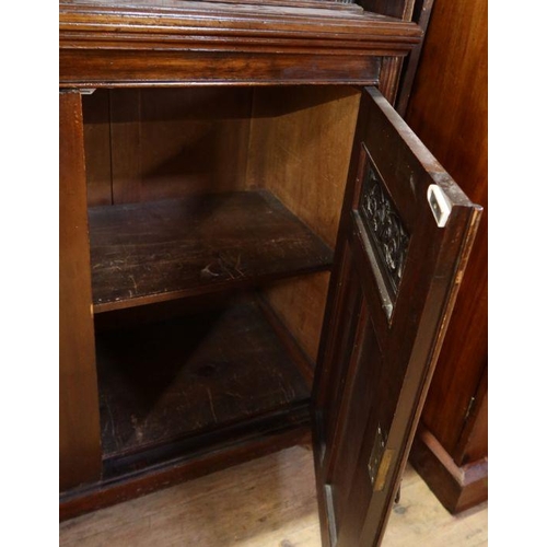 3 - An Edwardian mahogany cabinet, the upper section having a pair of glazed doors with adjustable shelv... 