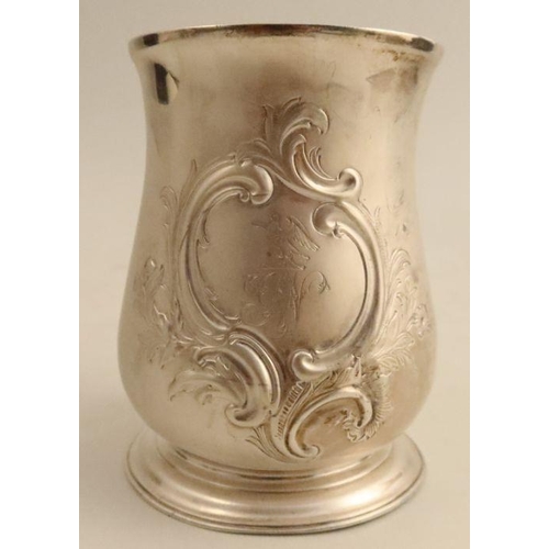 317 - A Georgian silver pint mug, with embossed decoration and engraved with a crest and initials, London ... 