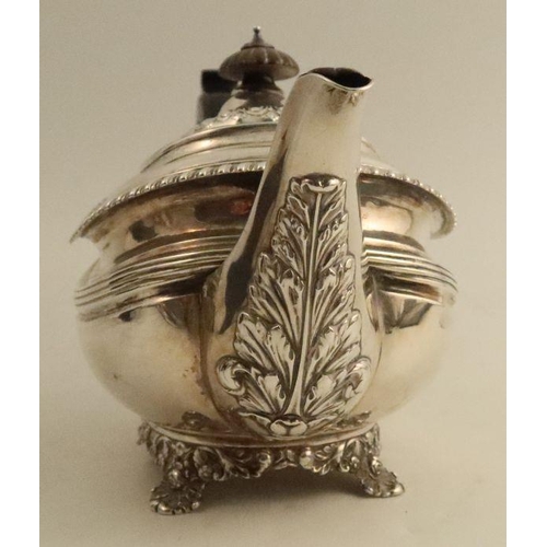 327 - A Georgian silver tea pot, with embossed leaf and gadrooned decoration, London 1824, maker Rebecca E... 