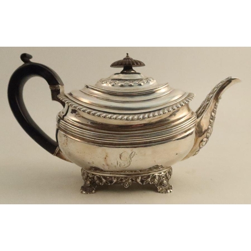 327 - A Georgian silver tea pot, with embossed leaf and gadrooned decoration, London 1824, maker Rebecca E... 