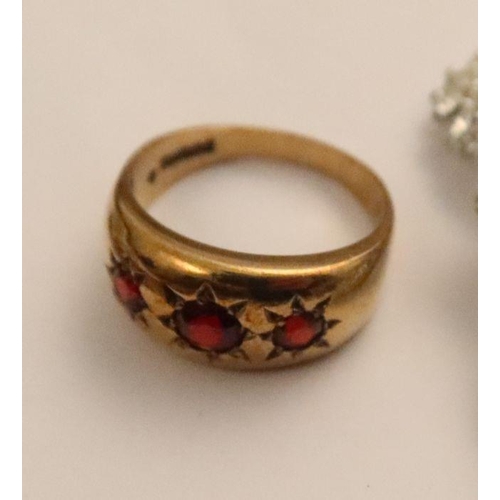 414 - A 9ct gypsy star set ring, of three graduated round-cut garnets, weight 3.6g, together with a pair o... 