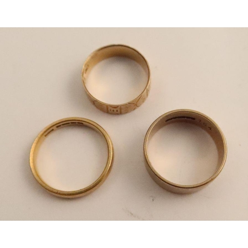 420 - A 22ct gold wedding band, weight 3.8g, together with an 18ct gold wedding band, weight 2.4g and a 9c... 