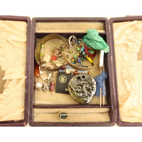 427 - A collection of costume jewellery, to include a Victorian silver necklace and locket, a hinged brace... 