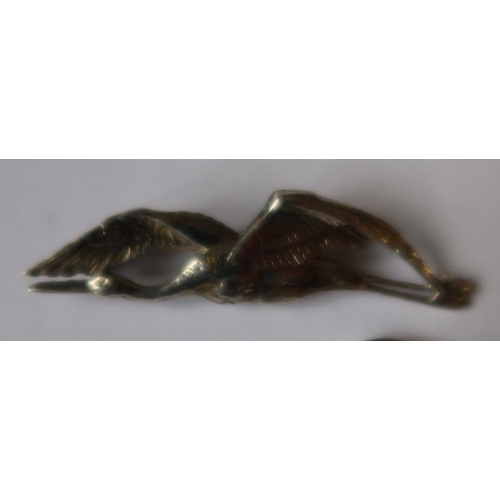 430 - A silver brooch, formed as a stork in flight, together with a silver ring set with paste stones