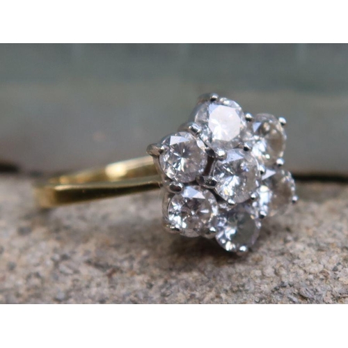 450 - An 18ct gold diamond flower head cluster ring, set with seven diamonds, approximately 1.4cts, marked... 