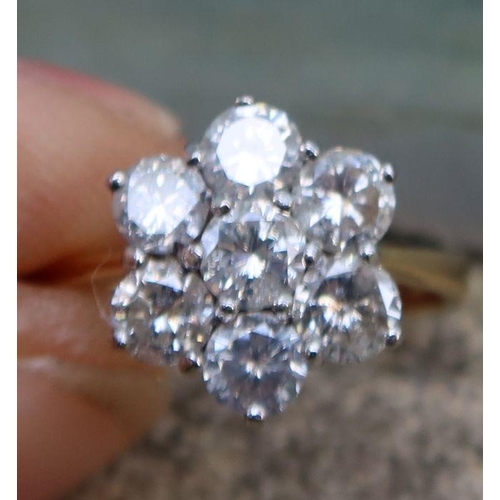 450 - An 18ct gold diamond flower head cluster ring, set with seven diamonds, approximately 1.4cts, marked... 