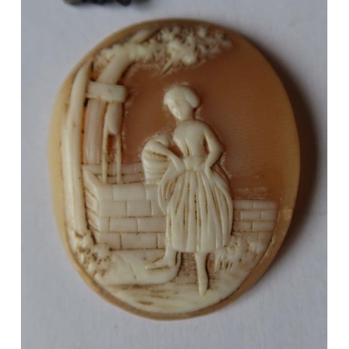 456 - An unmounted shell cameo, carved with a girl by a well, diameter 1.75ins, together with a moulded br... 