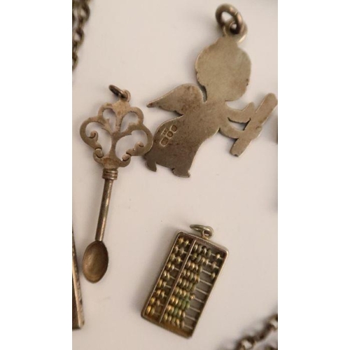 478 - A white metal chain, suspending silver and blue enameled T fob, stamped GVCCI, a silver cased pocket... 