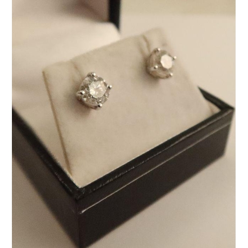 484 - A pair of diamond stud earrings, claw set in white gold, total weight of diamonds approx. 2.6cts