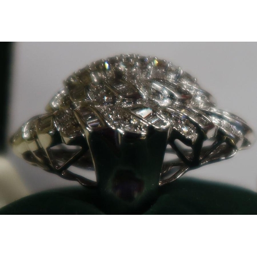 486 - A diamond dress ring, with marquise shape mount, set numerous baguette and round brilliant cut diamo... 