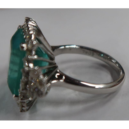 487 - An 18ct white gold emerald and diamond dress ring, the claw-set square-cut emerald approx 13.56 mm x... 