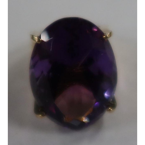 488 - A 14k amethyst dress ring, four claw set oval-cut purple amethyst, 13.2g