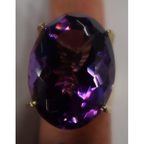 488 - A 14k amethyst dress ring, four claw set oval-cut purple amethyst, 13.2g