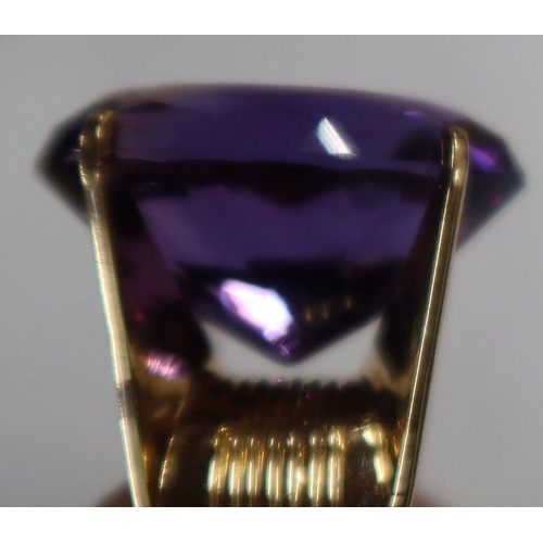 488 - A 14k amethyst dress ring, four claw set oval-cut purple amethyst, 13.2g