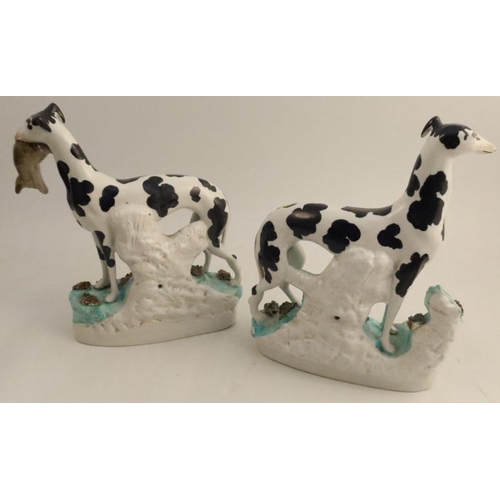 531 - A pair of Staffordshire flatback models, of black and white grey hounds with dead rabbits, height 11... 