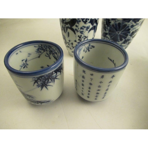 538 - A collection of oriental porcelain to include a pair of brush pots one af, a vase decorated with fig... 