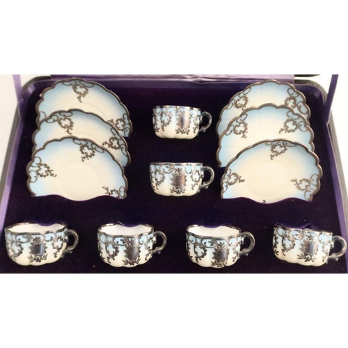 568 - Six cased Continental porcelain cups and saucers, in blue and white with sliver overlay, printed EES... 