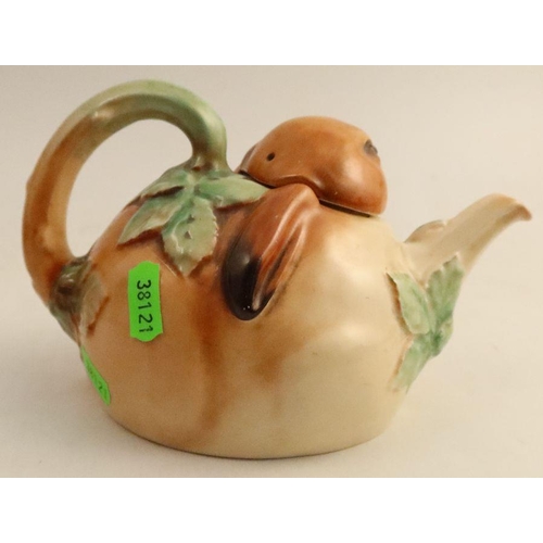 569 - A Royal Doulton Bunnykins novelty teapot, formed as a rabbit head and leaves - The teapot has some s... 