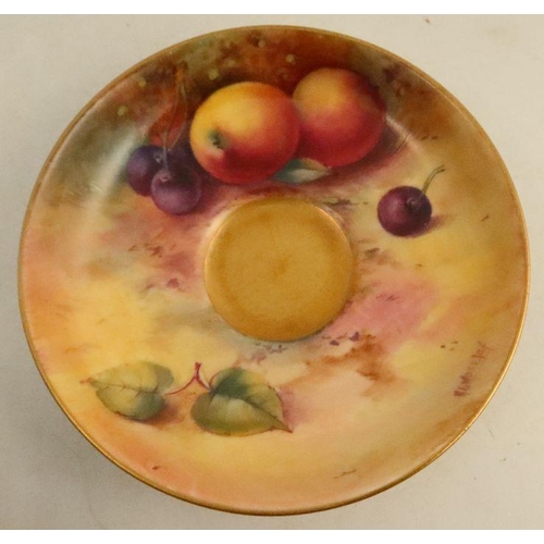 585 - A Royal Worcester cup and saucer, the exterior of the cup and the saucer decorated with fruit to a m... 