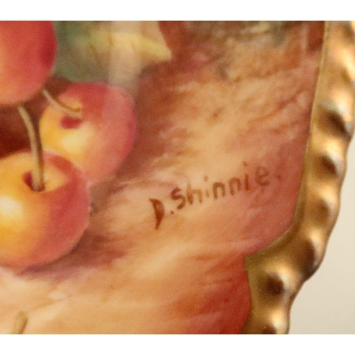 597 - A Royal Worcester side plate, decorated with fruit to a mossy background by Shinnie, with shaped gil... 