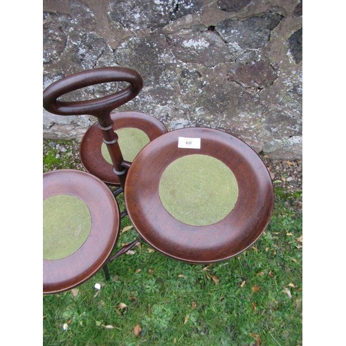 60 - A mahogany three tiered cake stand, with central handle and three circular dishes at different heigh... 