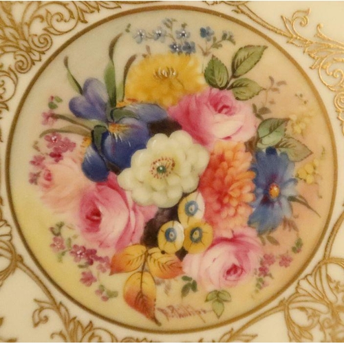 600 - A Royal Worcester cabinet plate, decorated with a central panel of flowers by Ernest Phillips, to a ... 