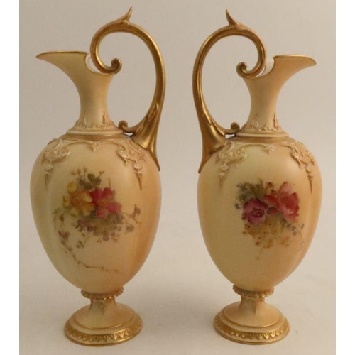 603 - A pair of Royal Worcester quarter lobbed ewers, decorated with flowers to a blush ivory ground, shap... 