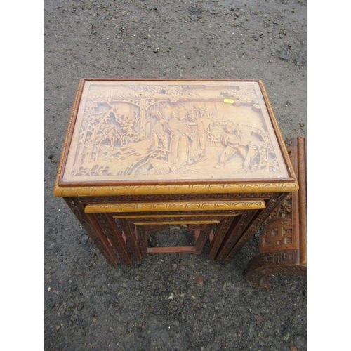 68 - An Eastern design coffee table, with relief decoration together with a similar design nest of tables