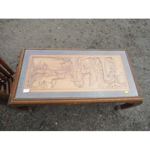 68 - An Eastern design coffee table, with relief decoration together with a similar design nest of tables