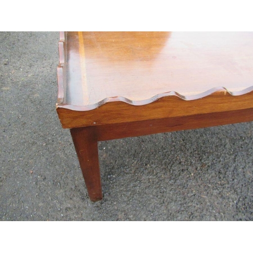 70 - A mahogany coffee table, with wavy edge, 45ins x 24ins, height 16ins