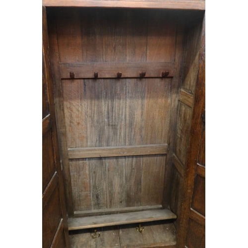 9 - An oak two door hall cupboard, with fielded doors and sides, width 38ins, depth 15ins, height 70.5in... 