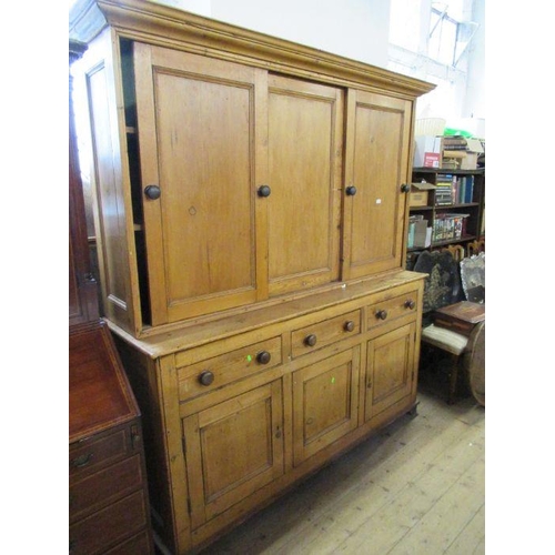 91 - A country pine cupboard dresser, the upper section having sliding doors to reveal shelves, width 75i... 