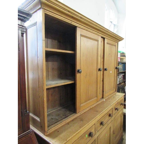 91 - A country pine cupboard dresser, the upper section having sliding doors to reveal shelves, width 75i... 