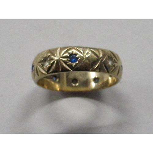 464 - A 9ct gold ring, with engraved decoration and set with alternate sapphires and diamonds, weight 3.7g