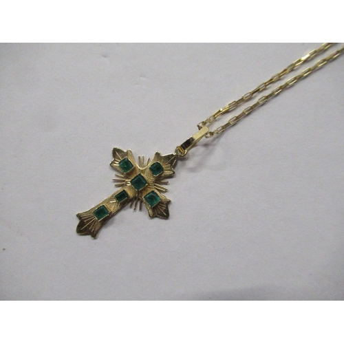 466 - An 18K gold cross pendant, set with emeralds, on an 18K gold fine link chain, weight 4.6g