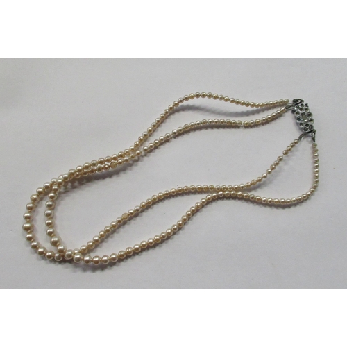 468 - A double string bead necklace, with paste clasp