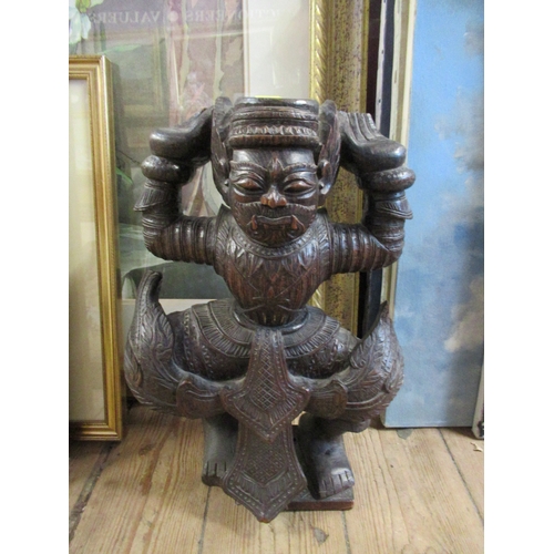 247 - A carved wooden model, possibly a tray or table base, in the form of an eastern figure, height 16ins