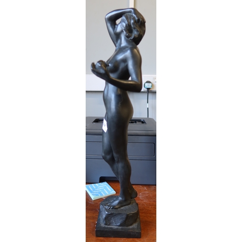 224 - A bronze figure of Eve, nude holding apple and raised on a pedestal height, titled temptation 20ins