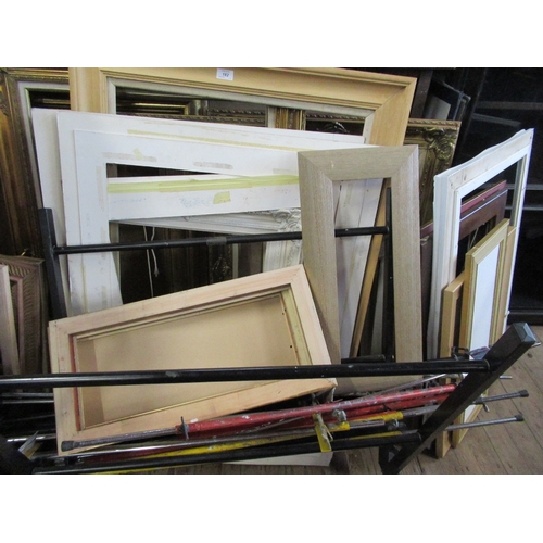 182 - A large collection of frames, mounts, folio stands and easels.