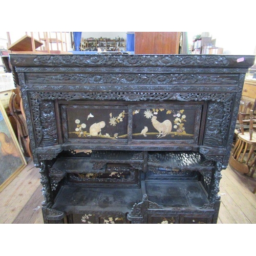 19 - An Oriental shibayama style cabinet, with relief decoration and  panels and decorated with foliage a... 