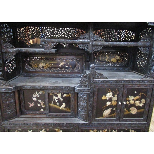 19 - An Oriental shibayama style cabinet, with relief decoration and  panels and decorated with foliage a... 