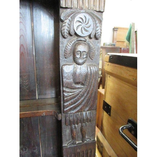 30 - An antique style oak dresser the upper section with carved figures width 46ins height 67