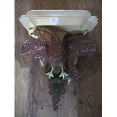 31 - A painted wall bracket decorated with a stylized eagle af  width 21ins height 20ins